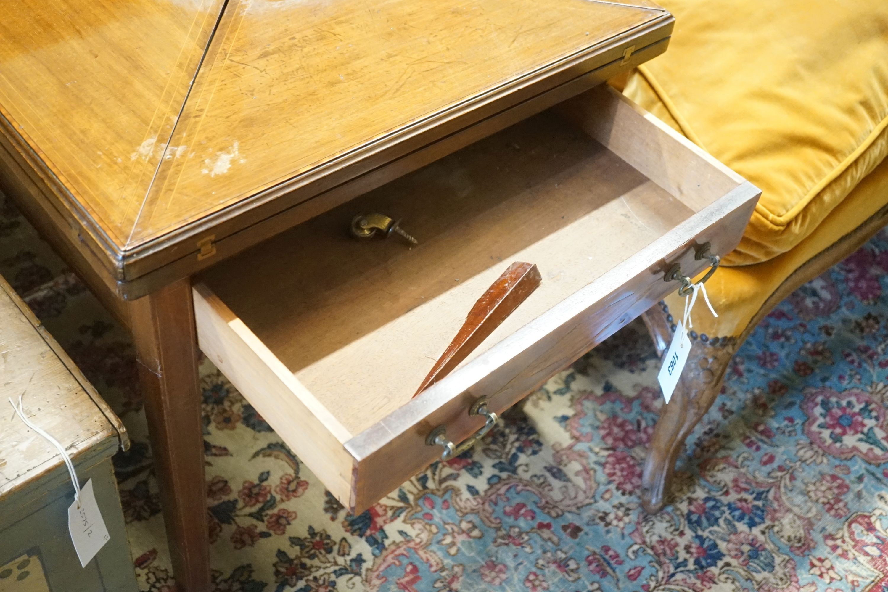 An Edwardian mahogany envelope card table, (cut down), width 56cm, depth 56cm, height 60cm